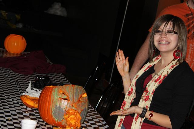 Krystina Martinez shows off her pumpkin creation at the Wesley Pumpkin carving party. Photo by Callie Grice.