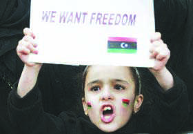 A child protests for freedom in Libya. Photo courtesy of ibtimes.com.