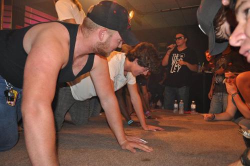 MC JD Newman hosts a push-up contest at Fifth Quarter. Photo courtesy of Wesley Foundation.