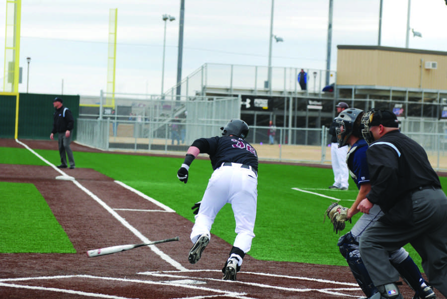 Jess Cooper launches himself to first base after a powerful hit.