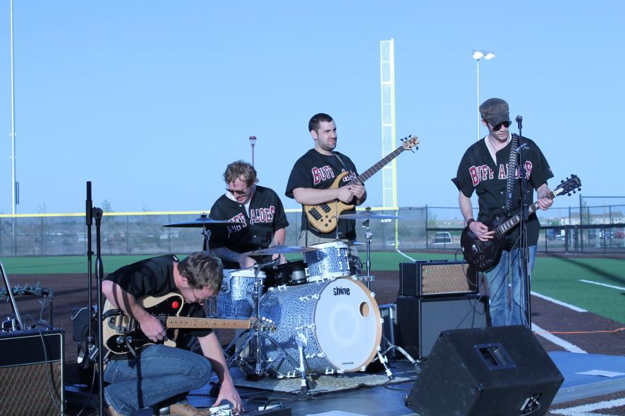 (L to R) Lead guitar player Ben Cargo, drummer Jordan McClain, bass player Steven Ronk and AJ Swope performing in the Lady Buffs Sports Yard. Photo by Daniela Fierro.