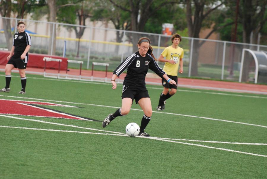 Kelsey Wright handles the ball midfield. Photo by Melissa Bauer-Herzog.