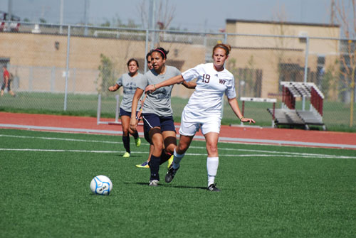 Rachel Roth and a WBU opponent head for the ball. Photo by Melissa Bauer-Herzog.
