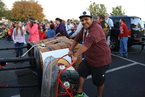 Junior Andrew Santos volunteers with setting up the ladybug hot air balloon. Photo by Danie Fierro.
