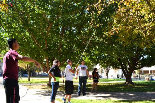 CAMPOS students help hang lights up around campus for Hanging of the Lights. Photo by Alex Montoya.