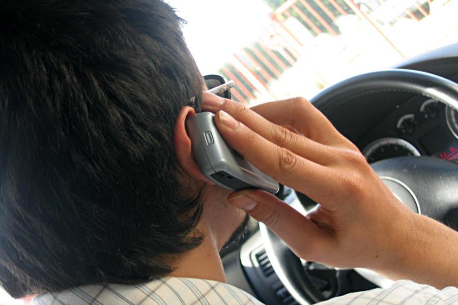 Man driving while on the phone. Photo courtesy of Stock Exchange.