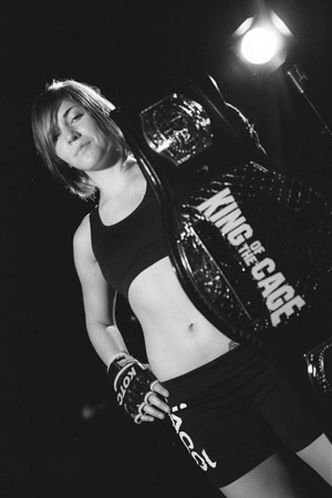 Photo courtesy of Sarah Alpar. Alpar shows off her King of the Cage title belt.