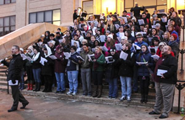 Students of the WTAMU Chorale singing traditional carols in front of Old Main. Photo by Natalia Molina.