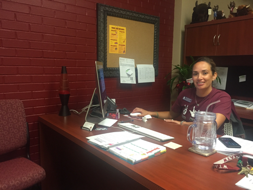 Elosia Reyna works at her desk in the Office of Student Engagement and Leadership.
