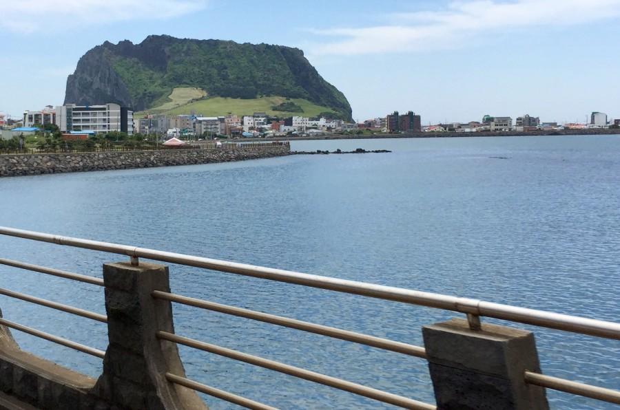 Sunrise Peak comes into view as Laura's tour bus approaches from Jeju City.