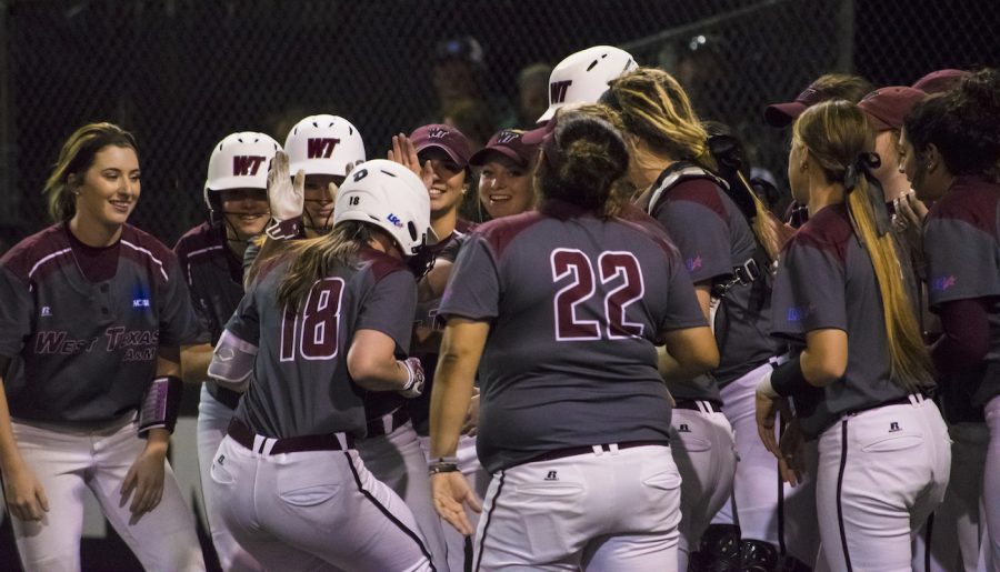 WTs designated hitter Allie Smith (18) comes into home plate with the team celebrating after hitting a home run against Fort Lewis on Feb. 11 at Schaeffer Park. 