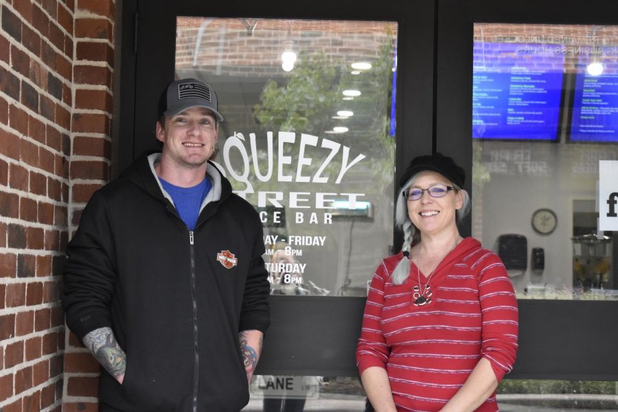 Owners Julie Simmons and Cody Hudson standing in front of the Squeezy Street Juice Bar on the Canyon Square.
