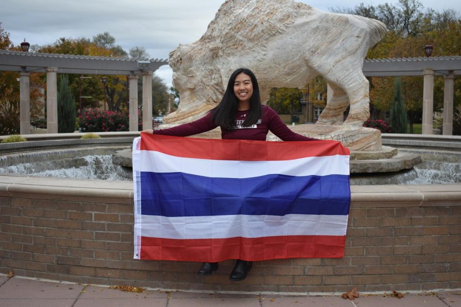 International student and junior electronic media major Loukyee Songprasert holding the Thailand flag. This flag is something that she keeps to remind her of home.  