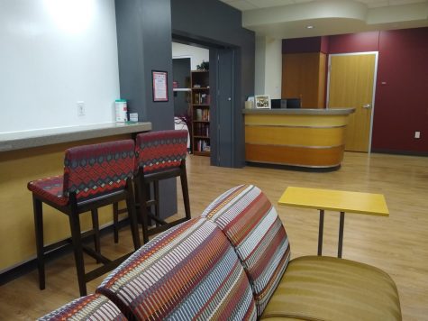 The Multicultural Centers lounge has multiple chairs, a TV and a bar with a whiteboard for artwork or mathematical equations, Thursday, Dec. 4, 2019.
