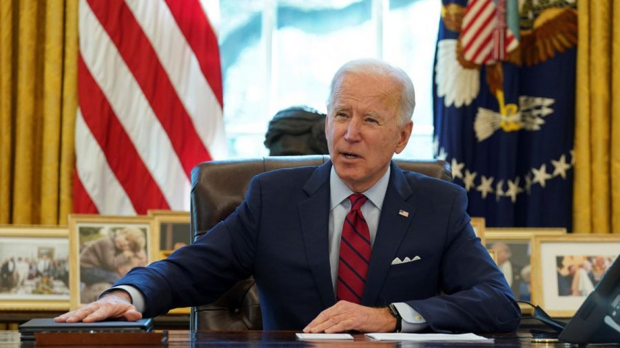 President Joe Biden pauses as he signs his first executive orders in the Oval Office of the White House on Wednesday, Jan. 20, 2021, in Washington D.C