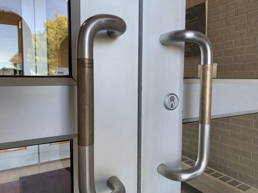Copper Clean patches sit on the east entrance door handles to the Sybil B. Harrington Fine Arts Comple