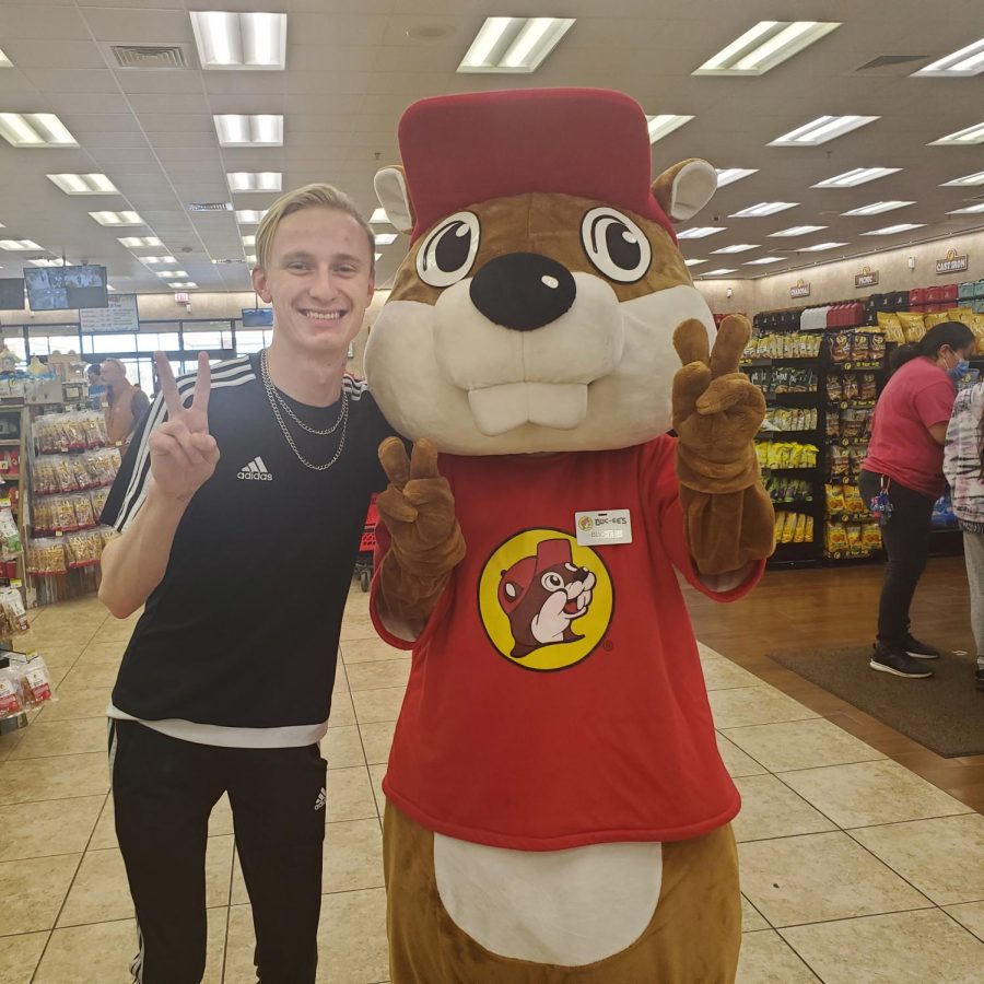 Zachary Unger throws up a peace sign with Buc-ee the Beaver at the second-closest Buc-ee's location, Store #37 in Fort Worth, Texas.