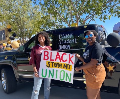 Tearanee Lockhart (right) poses with the Black Student Union float for the 2021 Homecoming parade. 