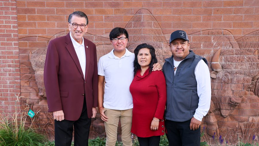 West Texas A&M University President Walter V. Wendler, left, congratulates the 2022 WT Family of the Year — sophomore Jose Trejo, second from left, and his parents Sara and Francisco Trejo of Gruver.