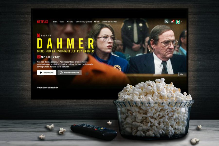 Scene from Dahmer Monster: The Jeffrey Dahmer story behind a bowl of popcorn and a remote control.