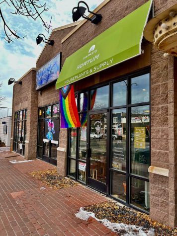 A pride flag flies in the window of a local business in Colorado Springs, CO, after the Club Q shooting, on Wednesday. 