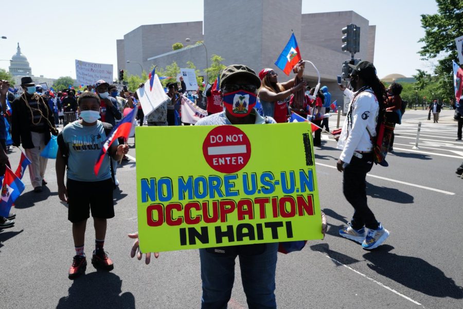 Washington, DC – May 18, 2021: Demonstrators marching along Pennsylvania Avenue to the White House to encourage the Biden administration in ending its support of Haitian President Jovenel Moise.