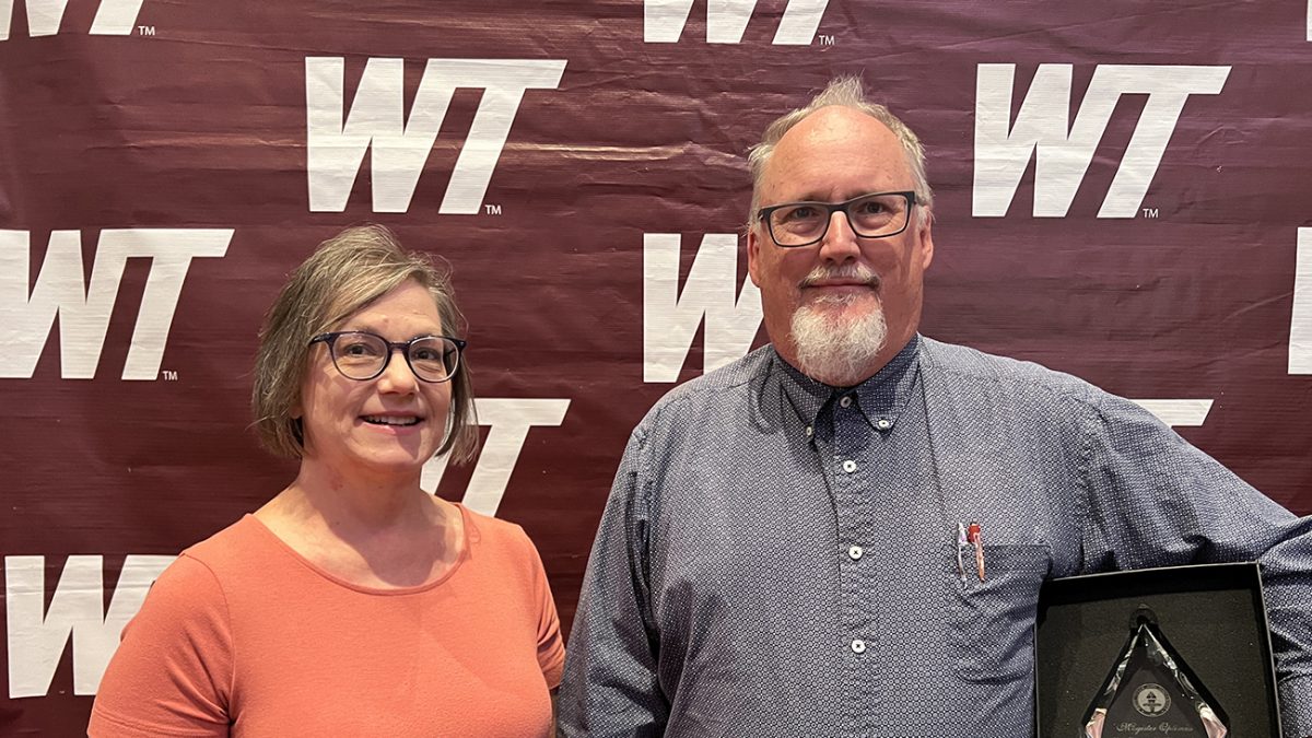 West Texas A&M University Registrar Diane Brice, left, was named the winner of the Clarence E. Thompson Staff Excellence Award and Dr. David Craig, associate professor of physics, was named 2023-24 Magister Optimus during Aug. 14 convocation exercises in Legacy Hall in the Jack B. Kelley Student Center on the WT campus.