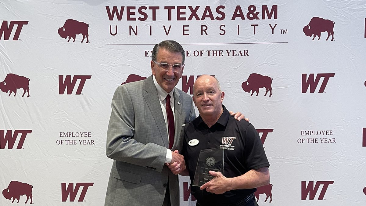 Mike Young, right, is congratulated by President Walter V. Wendler for winning the West Texas A&M University Employee of the Year.