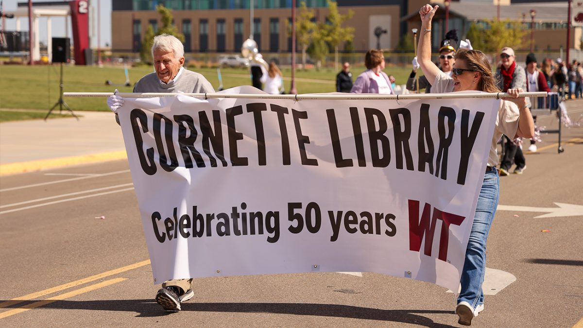 Jim Cornette and daughter Betsy Cornette marched at the head of the Cornette Library entry in the Oct. 14 Homecoming Parade at West Texas A&M University.