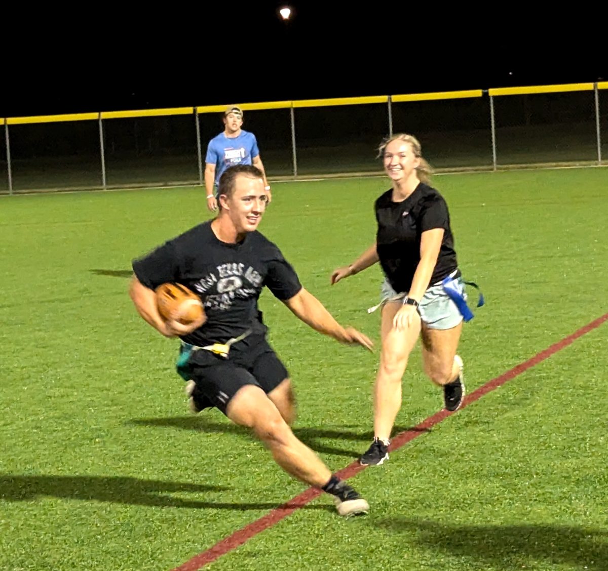 A student on one of WT's Flag Football teams runs away from a defender during the middle of a game on Sept. 18, 2024 at Buffalo Sports Field.