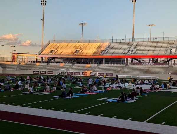 Students wait to begin a group yoga session inside Bain-Schaefer Buffalo Stadium at 7:00 p.m. on Sept. 23.