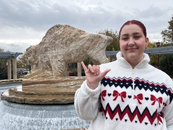 Lily Forbes stands in front of the WTAMU Buffalo Fountain.