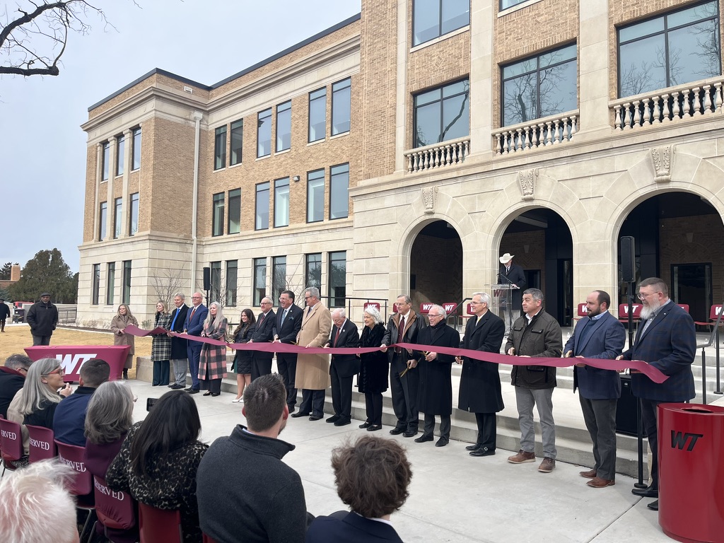 Speakers and distinguished guests cut the ribbon for the grand opening of the Geneva Schaeffer Education Building. 